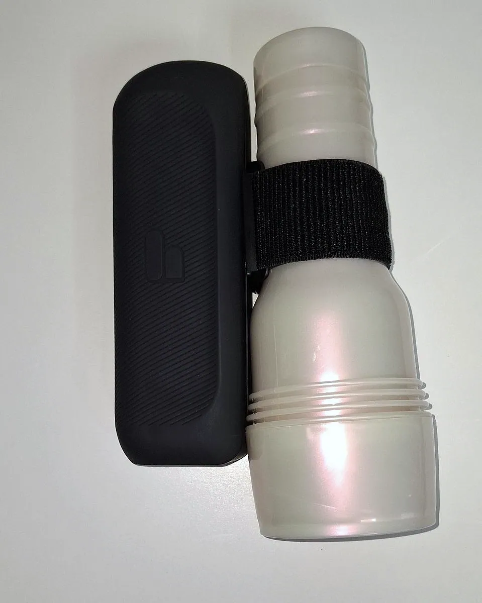 A Fleshlight in its case held against the Handy 2 by the band, seen from above